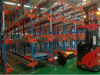 The Automated Pallet Shuttle is a compact storage system that employs an electric shuttle to load and unload pallets from racking automatically.