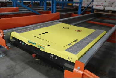 Pallet Shuttle moves along the storage lanes through a special set of rails embedded in the racks to lower and lift the pallet load to perform storage.